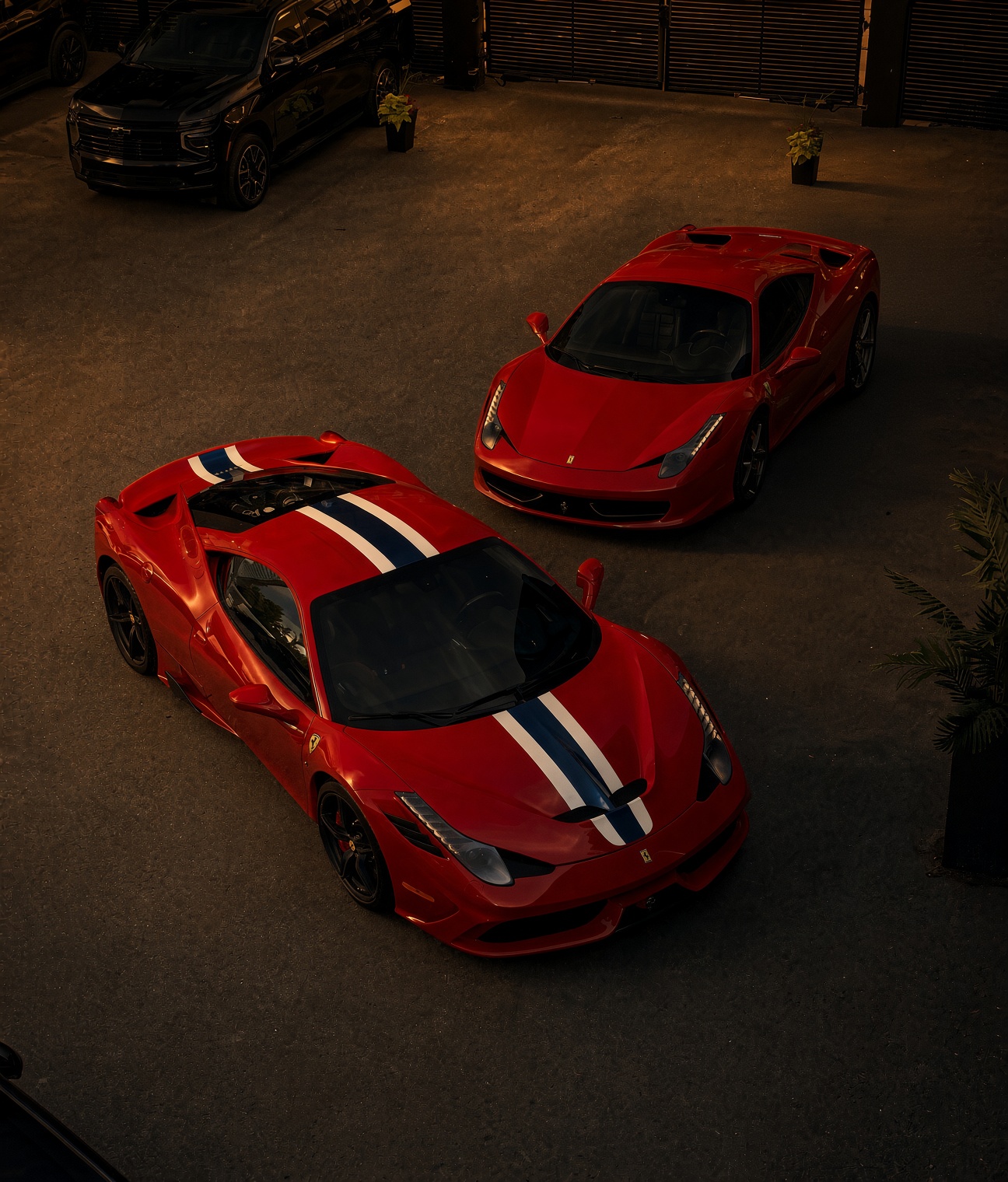 Two red Ferraris in the yard